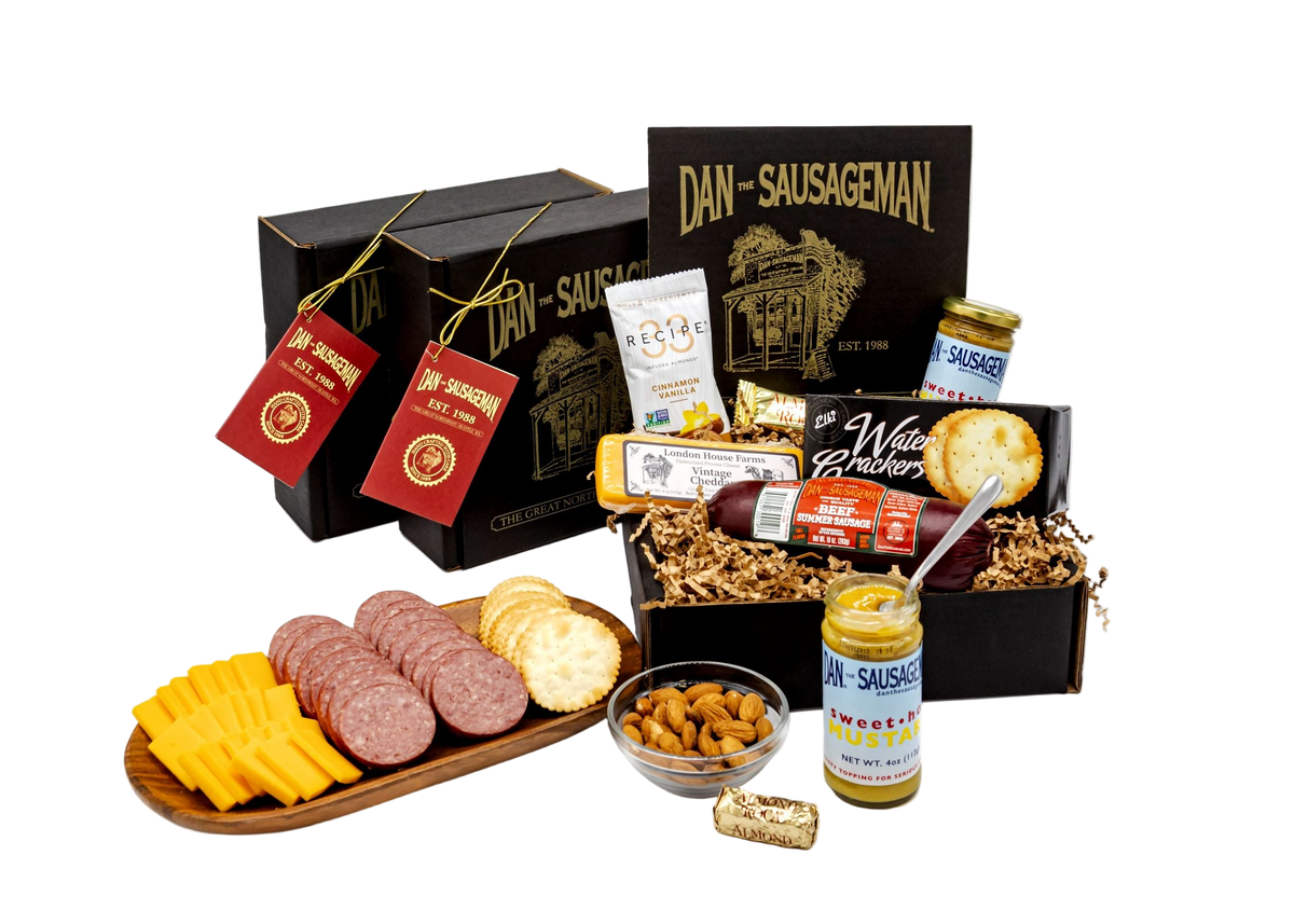 An open Dan the Sausageman gift box with summer sausage, cheese and mustard