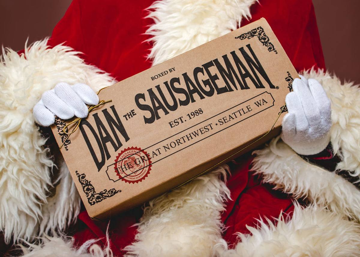 Santa holding a Dan the Sausageman gift crate stamped Seattle, WA