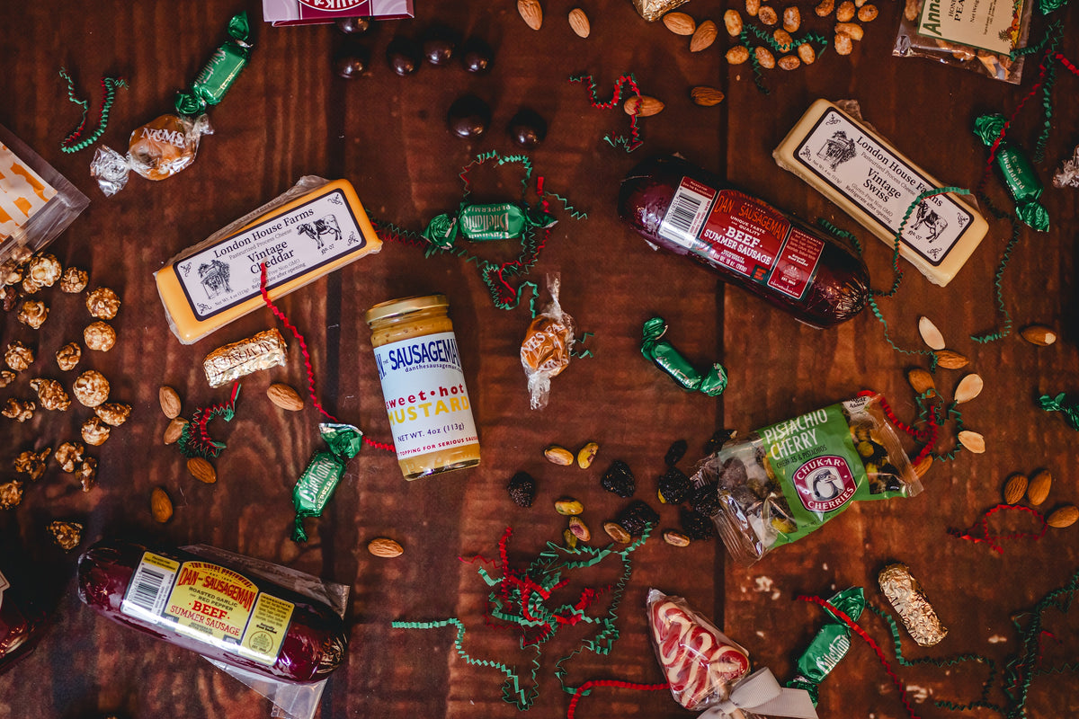A festive flat lay of Dan the Sausageman summer sausage, cheese and treats